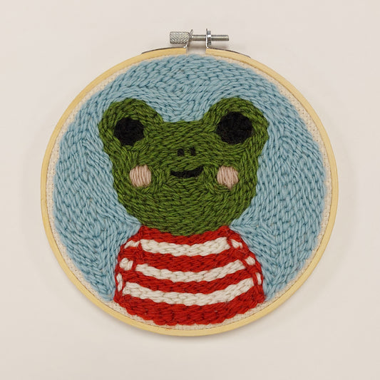 Sampi -taulu, tuftattu taulu, jossa kuvana sammakko